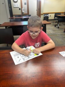 kid coloring a sport coloring page